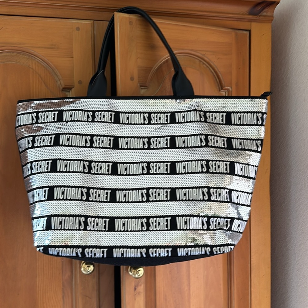 Victoria’s Secret black and silver sequin tote bag with a zipper top.